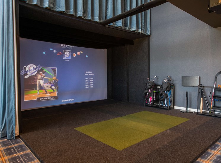 Indoor virtual golf game with grass pad and giant projector screen